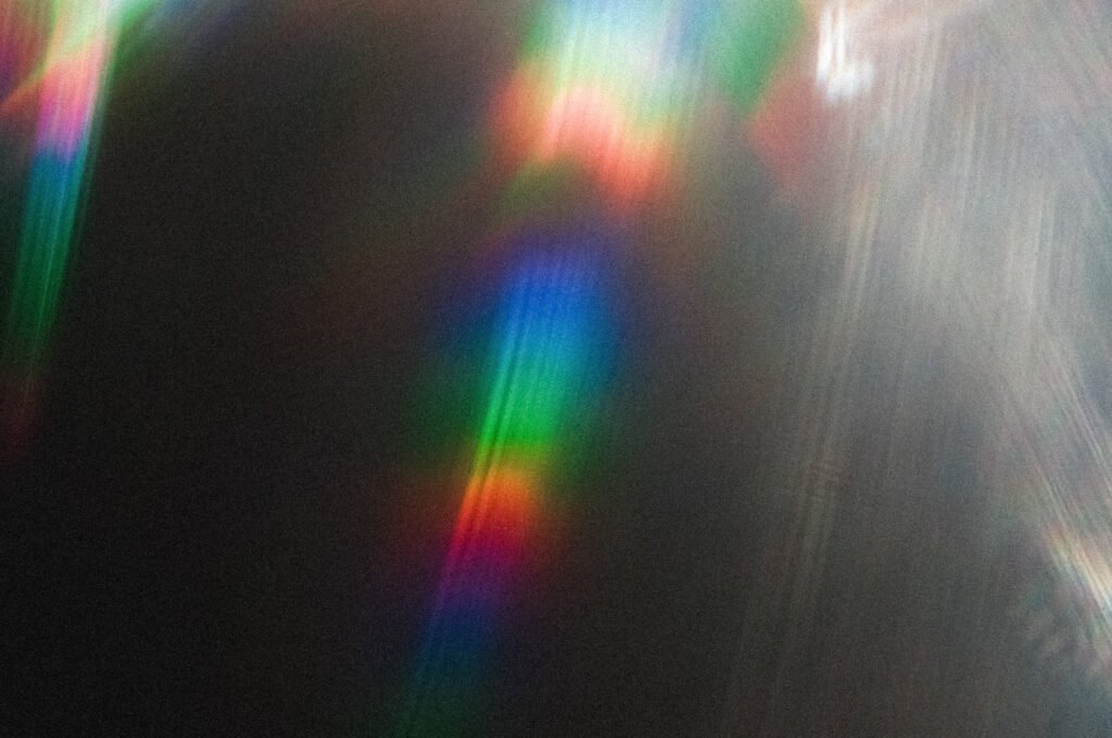 Emetophobia Therapy for Adults: ERP for the Fear of Vomiting 1 Abstract photograph of a single beam of light refracting into overlapping bands of color against near-black, evoking an ordinary signal becoming amplified and distorted into alarm