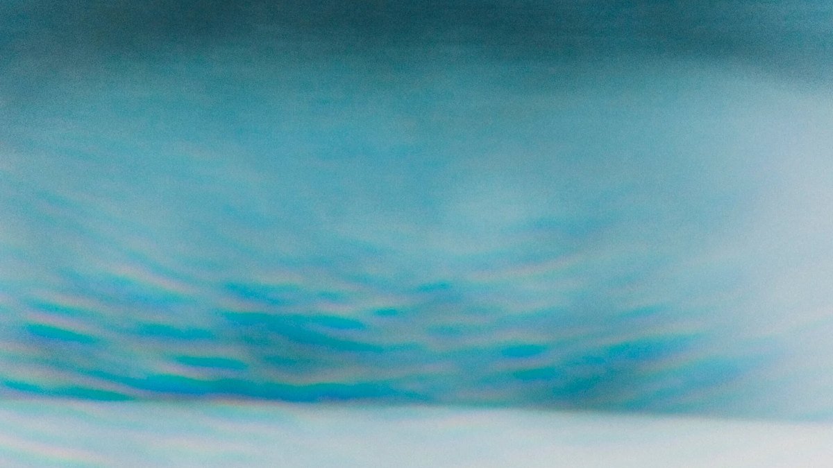 Skin Picking, Hair Pulling & Other BFRBs 1 Abstract photograph of teal organic wave texture beneath a pale horizon