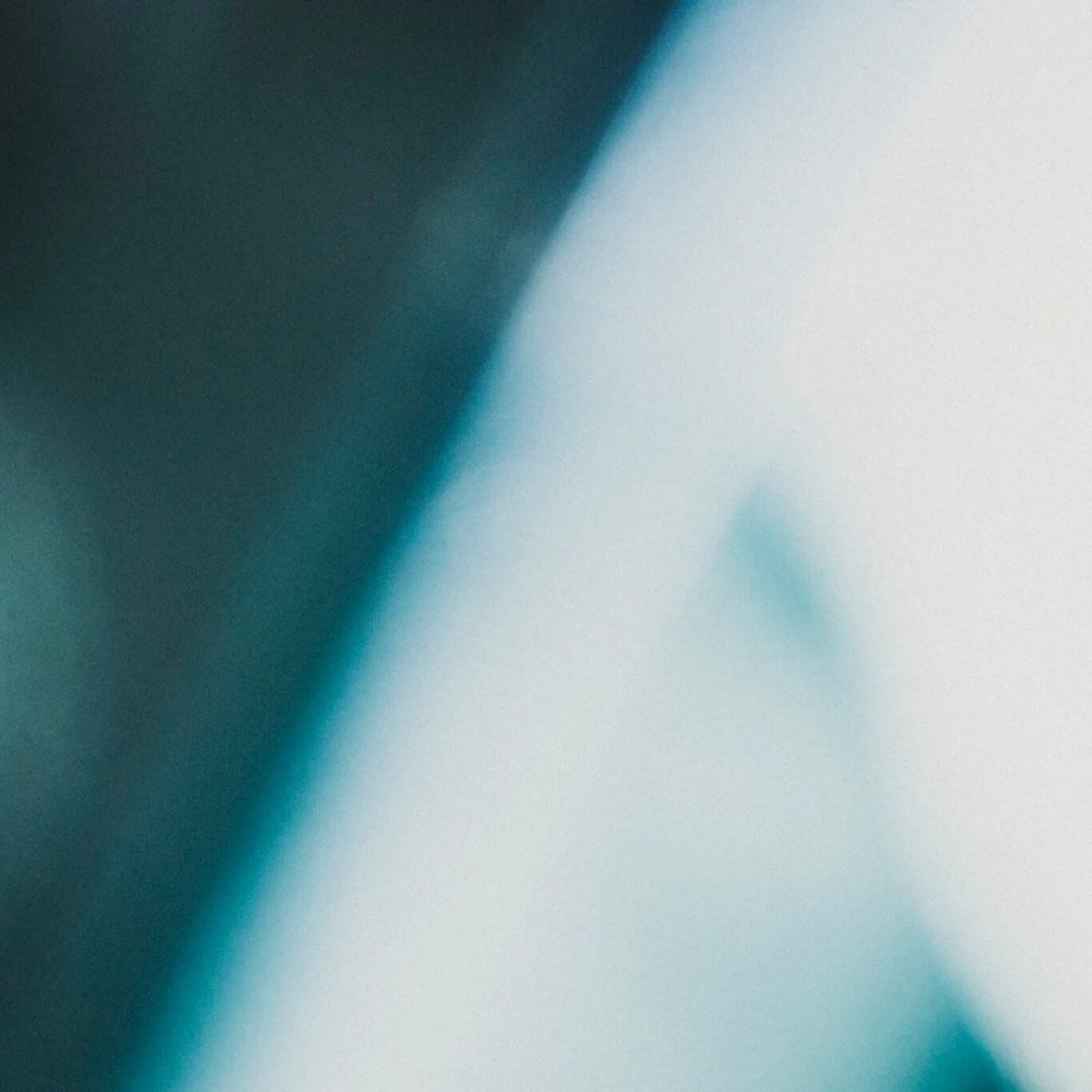 Trauma-Informed Therapy 1 Abstract photograph of dark teal shadow meeting bright light along a diagonal edge
